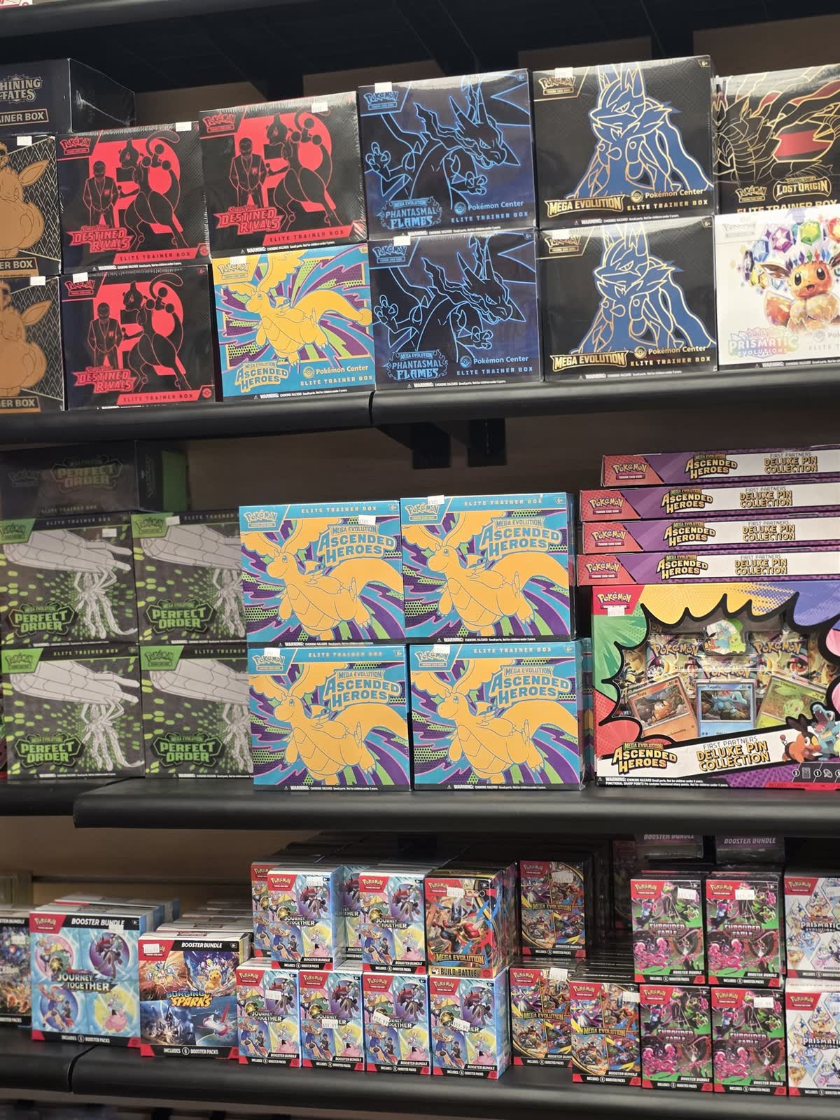 Wall of sealed Pokémon product at GG Hobby